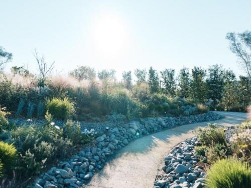 a garden with rocks and plants on a road at GREENITY IWATA in Iwata