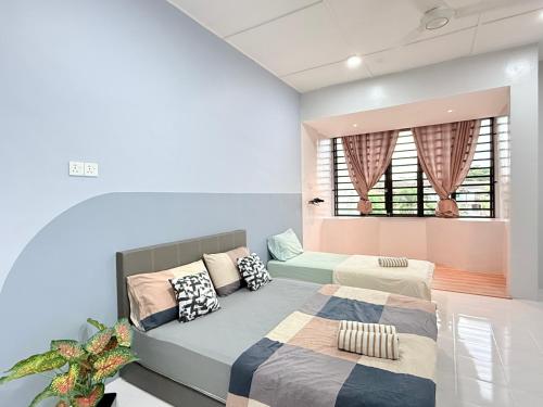 a bedroom with two beds and a window at Near TC Beach Alor Akar 4R3B fully AC Town area in Kuantan