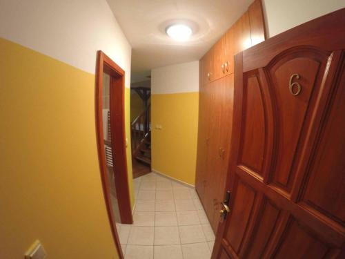 a hallway of a room with a door and yellow walls at Penzion U Holuba in Hradčovice