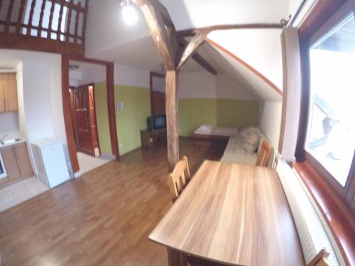 a living room with a wooden table and chairs at Penzion U Holuba in Hradčovice