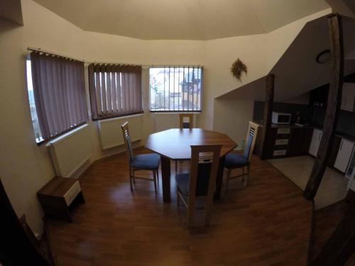 a dining room with a table and chairs at Penzion U Holuba in Hradčovice