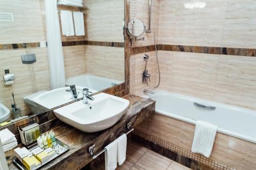 a bathroom with a sink and a tub at Chaika Hotel in Kaliningrad