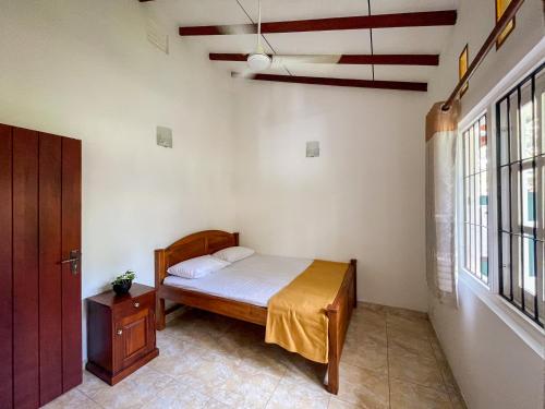 Postel nebo postele na pokoji v ubytování 007 Negombo