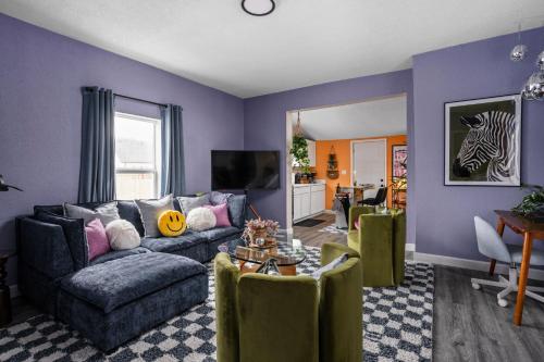 a living room with a couch and a table at Vibrant Downtown Indy Retreat with Game Room & Patio in Indianapolis