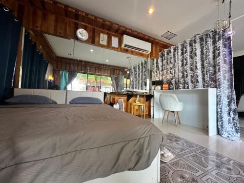 a bedroom with a bed and a table and chairs at Honey moon party in Ban Khlong Mae Nam