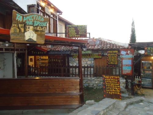 a store with signs on the side of a building at Traditional Guesthouse Archontoula in Palaios Panteleimon