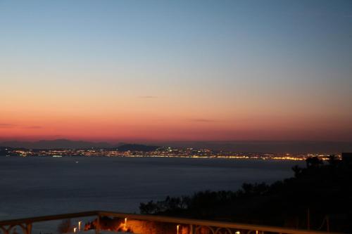 a view of the ocean at sunset at Hotel Prestige in Sorrento