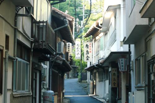 an alley with buildings and signs in an asian street at HÏSOM in Ōda