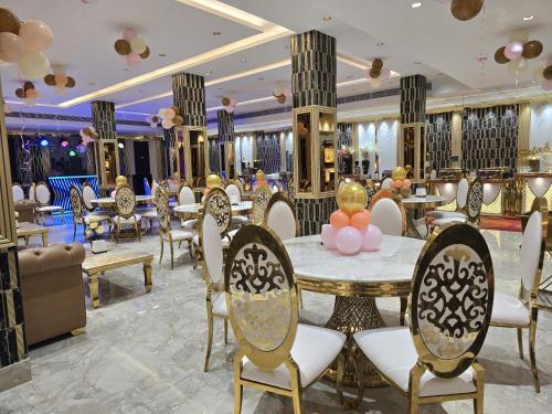 a restaurant with a table and chairs in a room at Rosewood Grand in Faridabad