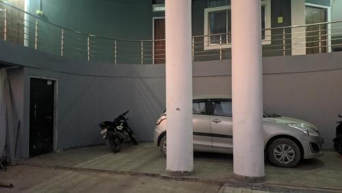 a car and a motorcycle parked next to a building at Hotel Horizon, Ziro in Ziro