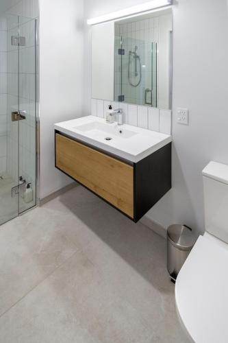 a bathroom with a sink and a mirror at Single-Level Retreat 1 bed 1 bath With Balcony in Christchurch