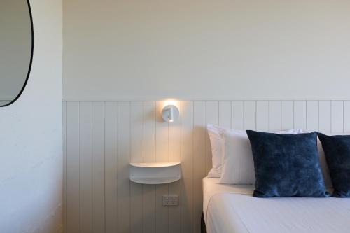 a bedroom with a bed with a blue pillow at Balmoral On York in Launceston