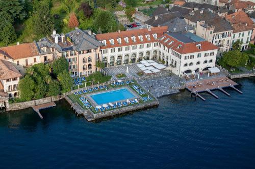 an aerial view of a building with a pool in the water at Hotel San Rocco in Orta San Giulio