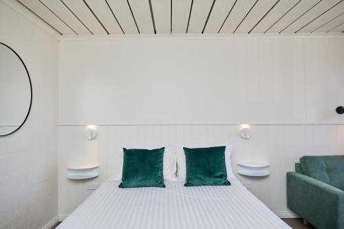 a bedroom with a bed and a green couch at Balmoral On York in Launceston