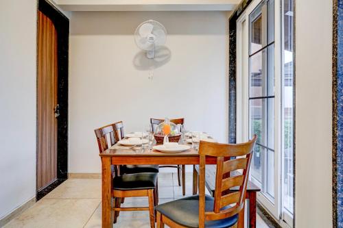 a dining room with a wooden table and chairs at ELIVAAS Irene Jade 3 BHK with Pvt Pool & Balconies in Lonavala