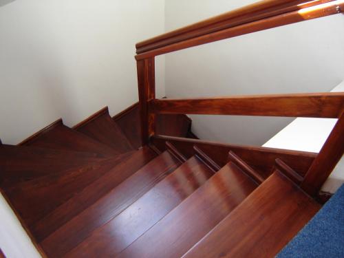 a wooden stair case with wooden steps in a room at Pension Kachlicka in Skála