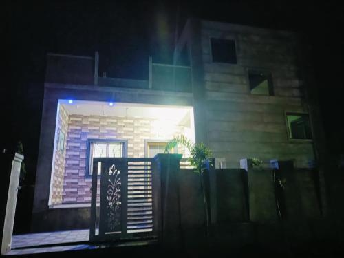 a house with a fence in front of it at night at Swami Krupa Guest House Akkalkot in Akalkot
