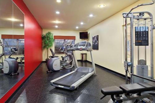 a gym with a treadmill and ellipticals in a room at Country Inn & Suites by Radisson, Elgin, IL in Elgin