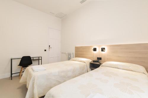 En eller flere senge i et værelse på Hostal Excelsior