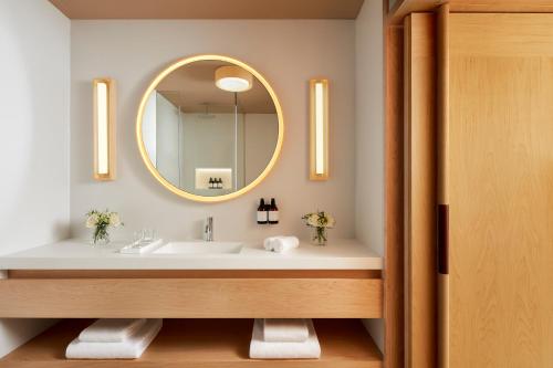 a bathroom with a sink and a mirror at Tivoli Estela Golf & Lodges Porto in Póvoa de Varzim