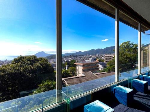 a view of the city from the balcony of a house at Yukemuri no sato azumaya in Beppu