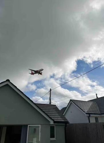 an airplane is flying over a house at White 3 bed bungalow with en-suite and parking in Winford