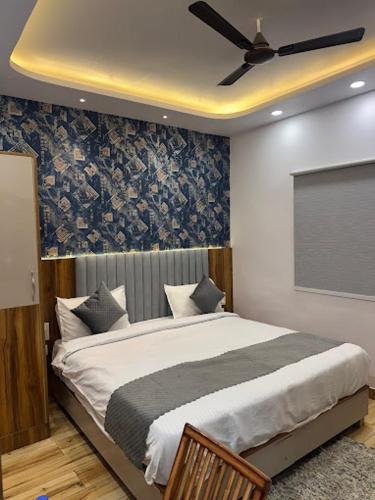 a bedroom with a bed with a ceiling fan at Hotel Strawberry in Chandīgarh