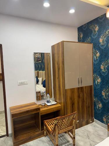 a room with a wooden cabinet and a mirror at Hotel Strawberry in Chandīgarh
