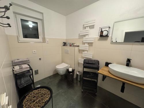 a white bathroom with a sink and a toilet at Viva la Wildbad in Bad Wildbad