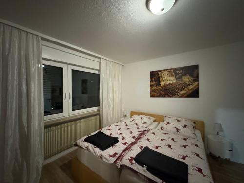 a bedroom with a bed and a window at Viva la Wildbad in Bad Wildbad