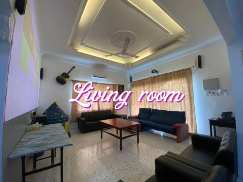 a living room with a couch and a living room sign at Bergstein Taiping in Taiping