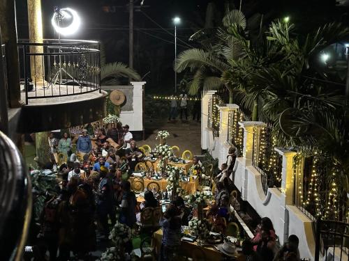 a crowd of people sitting at tables at an event at MICASO Guest House in Limbe