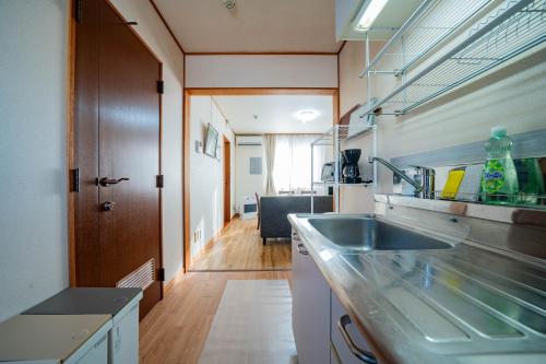 a kitchen with a sink and a counter at Yadokito 1 in Otaru