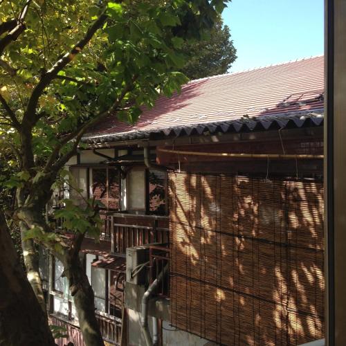 a building with a tree in front of it at 中棚荘 in Komoro