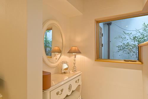 a bathroom with a dressing table and a mirror at Dongparang hanok stay in Gyeongju