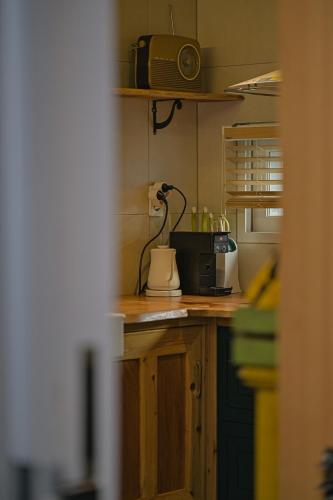 a kitchen with a counter with a toaster and a microwave at Dongparang hanok stay in Gyeongju