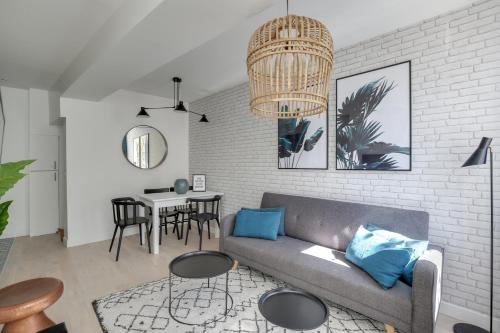 un salon avec un canapé et une table dans l'établissement Promenade Best Bakeries from a Cozy Boho 1 Bedroom, à Paris