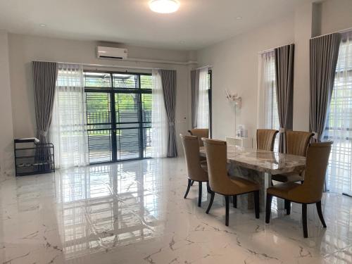 a dining room with a table and chairs at Hillview Terrace in Hat Yai