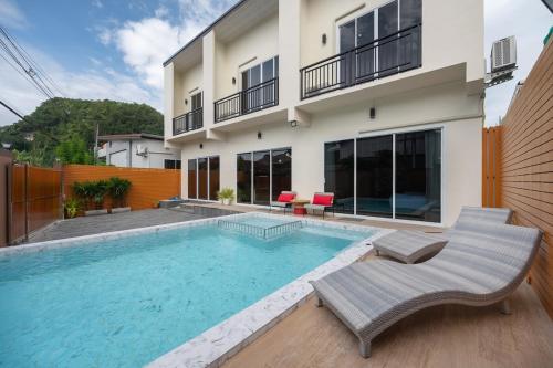 a swimming pool in front of a house at Sea eagle Triple house 7 bedrooms in Aonang in Ao Nang