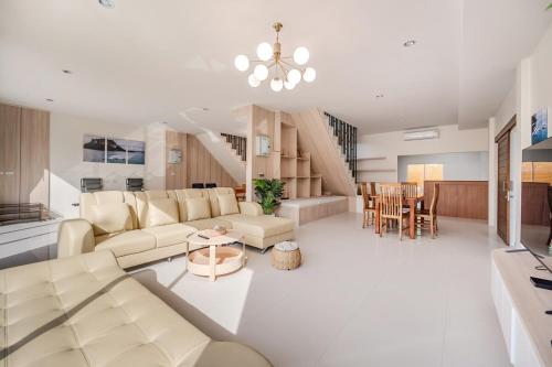 a living room with a couch and a table at Sea eagle Triple house 7 bedrooms in Aonang in Ao Nang