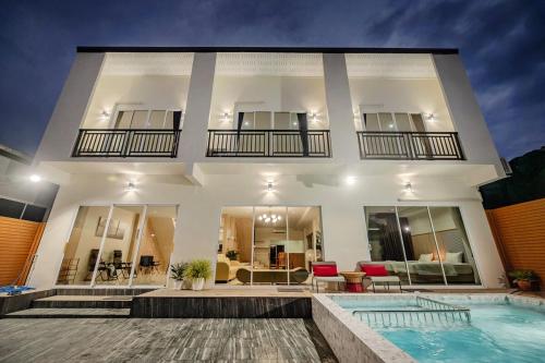 a house with a swimming pool in front of it at Sea eagle Triple house 7 bedrooms in Aonang in Ao Nang