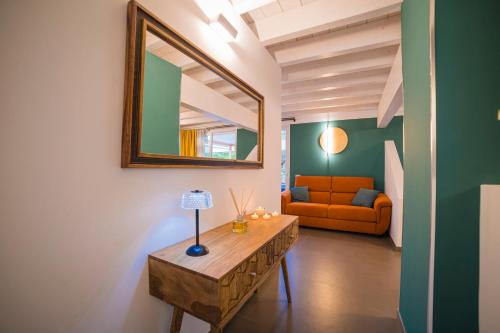 a living room with a table and a mirror at Sweet Loft Maglie in Maglie