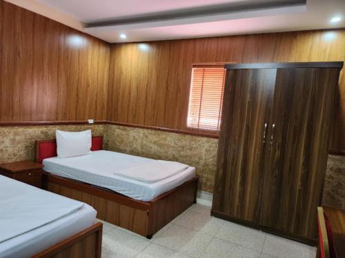 a small bedroom with two beds and a window at Quỳnh Vy Hotel Thái Nguyên in Thái Nguyên