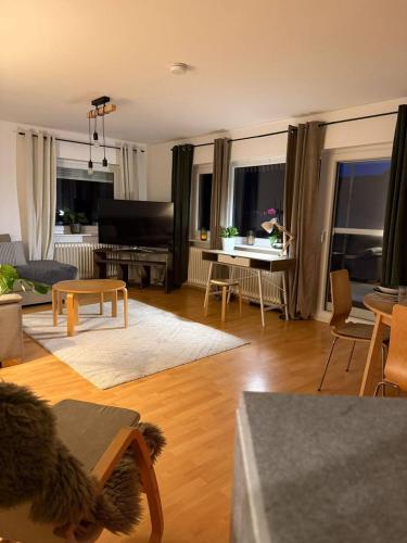 a living room with a couch and a piano at Voll ausgestattete, helle Ferienwohnung auf 80 qm in Wutöschingen