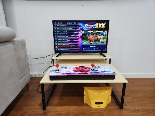 a table with a computer on top of it at Paju Heyri Hills Modern House in Paju