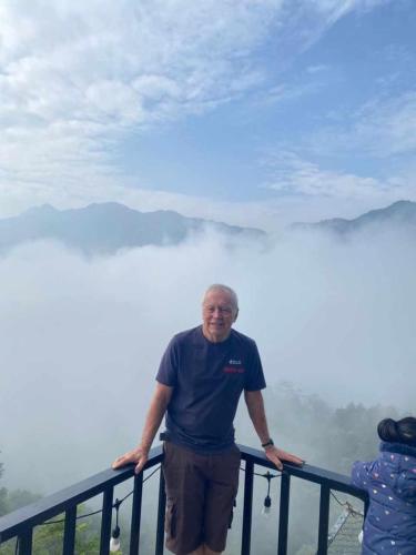 a man standing in front of a railing on a mountain at Muong Thanh Homestay in Diện Biên Phủ