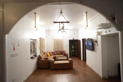 a living room with a couch and a tv at Mango Farm Villa in Thūr
