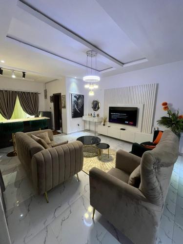 a living room with two couches and a tv at Tokyo in Lagos