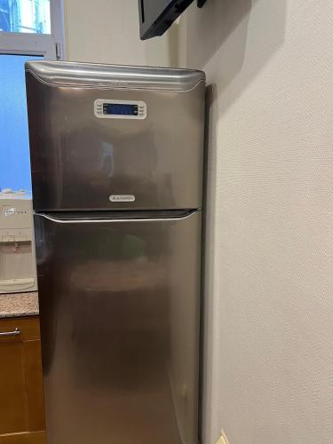 a stainless steel refrigerator in a kitchen at Cozy apartment in the heart of Baku in Baku