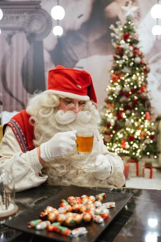 a man dressed as santa claus holding a cup of tea at Gate Twenty Two Boutique Hotel in Nicosia